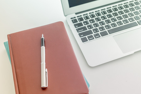 Still-life portrait of computer with bookの写真素材