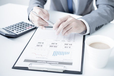 business, technology and internet concept - close up of man hands with coffee and laptop computerの写真素材