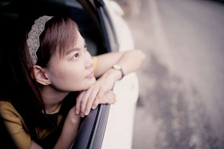 oung woman in her new car smiling.の写真素材