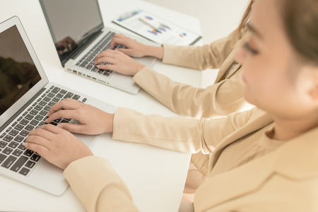 Business people discussing the charts and graphs showing the results of their successful teamworkの写真素材