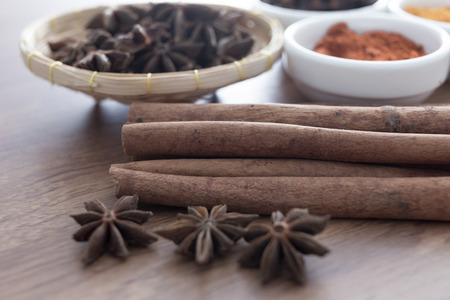 Wooden table of colorful spicesの写真素材