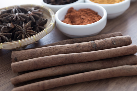 Wooden table of colorful spicesの写真素材