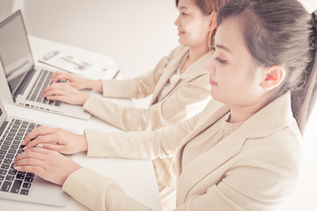 Business people discussing the charts and graphs showing the results of their successful teamworkの写真素材