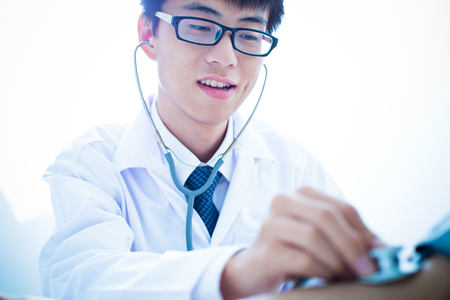 Bright picture of male doctor with patientの写真素材
