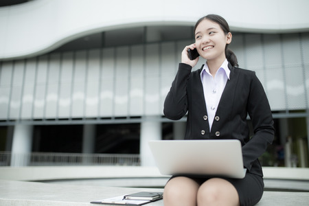 Young businesswoman using mobile phoneの写真素材