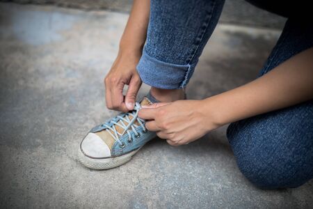 Closeup of Young Woman Tying Sports Shoeの写真素材