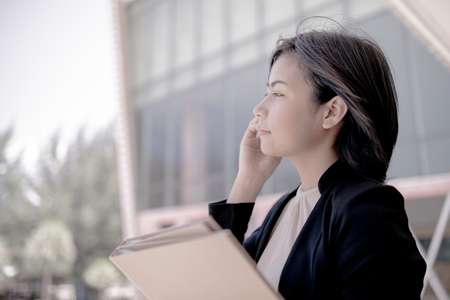 Young businesswoman using mobile phoneの写真素材