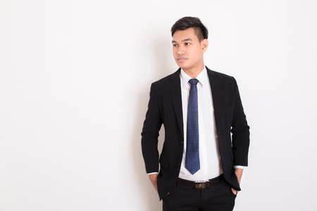 Portrait of young happy smiling business man, isolated over white backgroundの写真素材