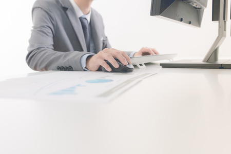 Businessman analyzing investment charts with computer. Accounting