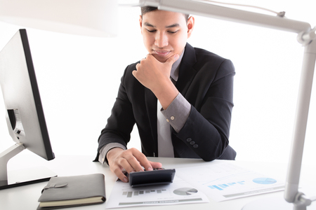 Businessman analyzing investment charts with laptop. Accountingの写真素材