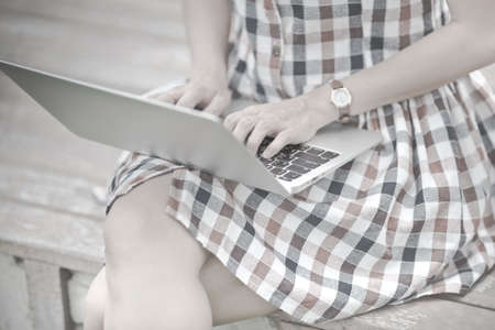 Young Caucasian woman using Laptop on natureの写真素材