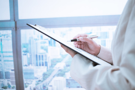 Woman taking notes during business meeting in the office.の写真素材
