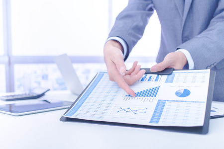 Businessman analyzing investment charts. Accountingの写真素材