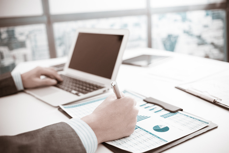 Businessman analyzing investment charts with laptop. Accountingの写真素材