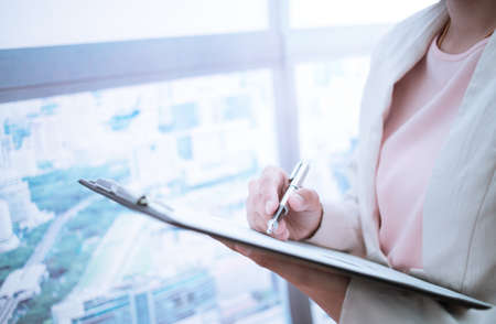 Woman taking notes during business meeting in the office.の写真素材