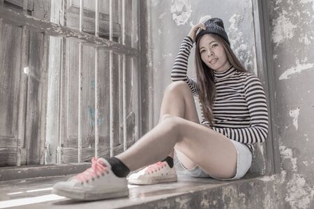 Young beautiful girl in abandoned houseの写真素材