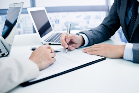 Business man signing a contractの写真素材