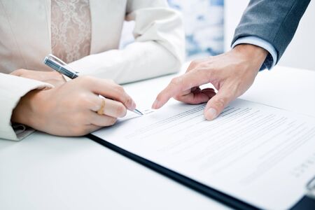 Female hand signing contract.の写真素材