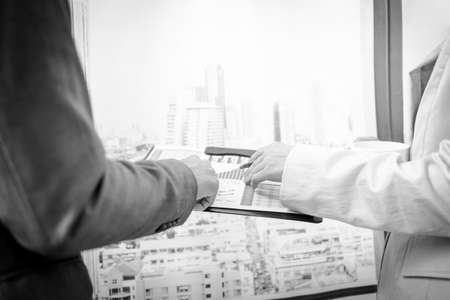 Business people discussing the charts and graphs showing the results of their successful teamworkの写真素材