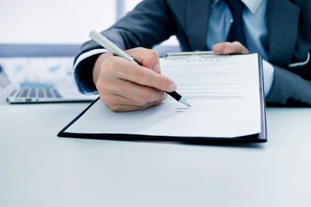 Business man signing a contractの写真素材