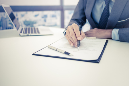 Business man signing a contractの写真素材
