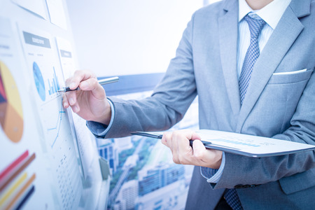 Businessman analyzing investment charts. Accounting Businessman analyzing investment charts. Accounting
