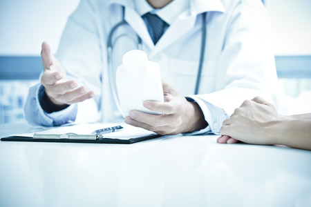 Close-up Of Male Doctor Filling The Medical Formの写真素材