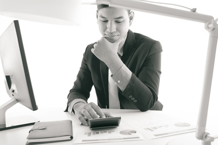Businessman analyzing investment charts with laptop. Accountingの写真素材