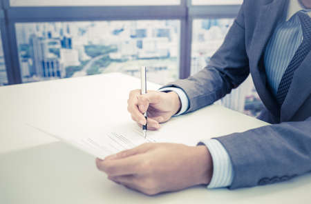Business man signing a contractの写真素材
