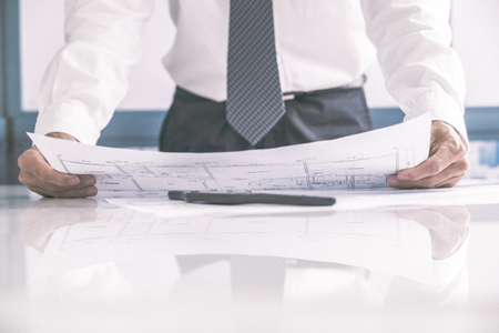 Architect working on blueprintの写真素材