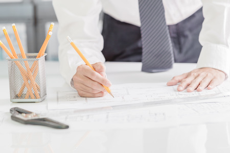 Architect working on blueprint