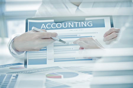 Business people discussing the charts and graphs showing the results of their successful teamworkの写真素材