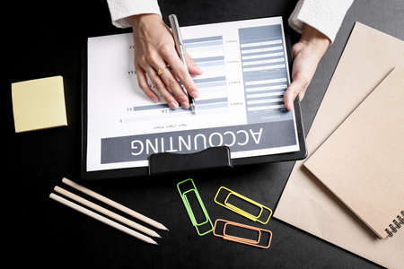 Business people discussing the charts and graphs showing the results of their successful teamworkの写真素材