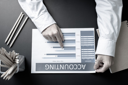 Businessman analyzing investment charts with laptop. Accounting