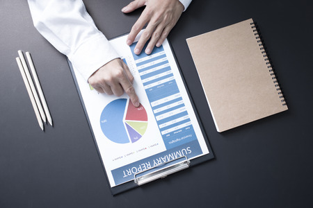 Businessman analyzing investment charts with laptop. Accounting