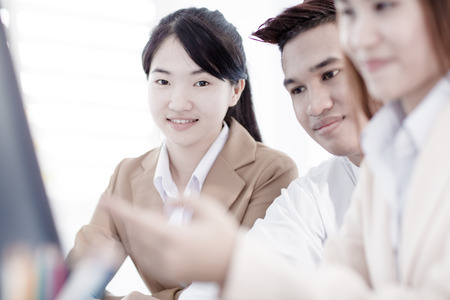 Business people discussing the charts and graphs showing the results of their successful teamworkの写真素材