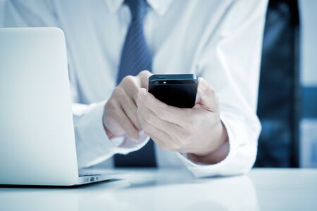 Close up of a man using mobile smart phoneの写真素材