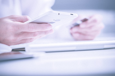 Man holding credit card in hand and entering security code using laptop keyboard