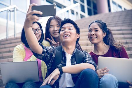 group of happy teen high school students outdoors