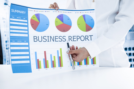 woman hand with pen and business reportの写真素材