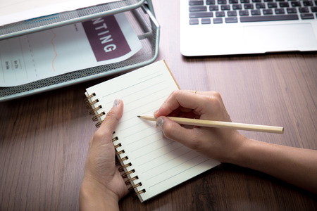 Handwriting, hand writes with a pen in a notebookの写真素材