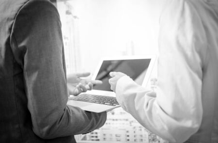 Business people discussing the charts and graphs showing the results of their successful teamworkの写真素材