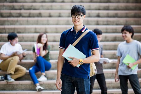 group of happy teen high school students outdoors