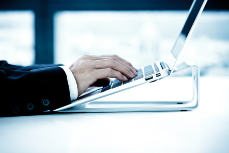 Closeup of businessman hands typing on laptop computer