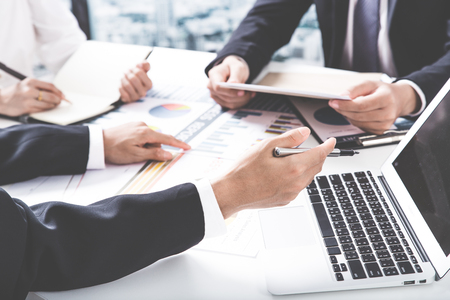 Business adviser analyzing financial figures denoting the progress in the work of the companyの写真素材