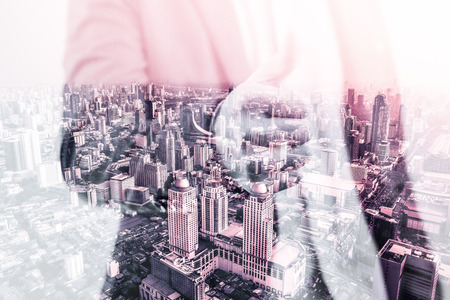Double exposure of businessman and cityの写真素材