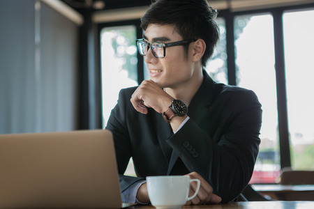 man, coffee, smile. Man in cafe looking into the camera. Interior portrait of a hot looking relaxed happy male modelの写真素材