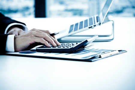 Businessman analyzing investment charts with laptop. Accountingの写真素材