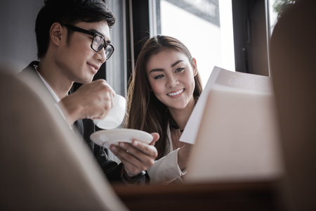 portrait of two business people discussing new project in coffee shopの写真素材