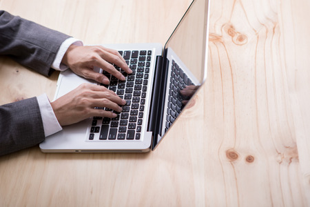 Closeup of businessman hands typing on laptop computerの写真素材